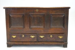 An 18th century oak mule chest with two drawers to base and panel front,