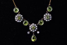 A yellow metal centrepiece necklace set with seed pearls and peridot together with two diamonds.