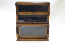 An oak standing bookcase with three Globe Wernicke style doors,
