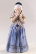 A Royal Copenhagen figure of a young girl in a bonnet and blue dress, No.