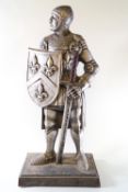 A cast metal doorstop in the form of a knight,