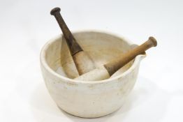 A large apothecary's mortar with two pestles,