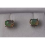 A pair of silver and natural Ethiopian opal studs. Approximately 1.