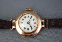 A yellow gold cased watch with ceramic Roman numeral dial. Hallmarked 9ct gold, 1912.