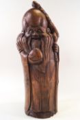 A carved bamboo figure of an oriental immortal,