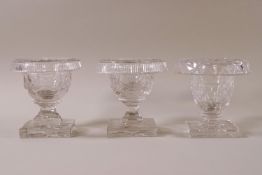 A pair of 19th Century cut glass salts with foldover rims and star cut pedestal bases, 8cm high,