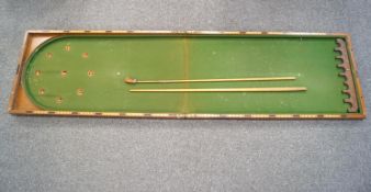 An Edwardian mahogany bar billiards with cues, mace and ivory balls, the folding case 106cm long,