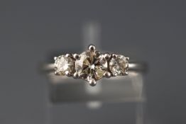 A white metal three stone diamond ring, approx 1.00ct. Hallmarked 18ct gold, London. Size: N 4.