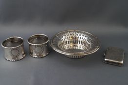 A silver pierced bon bon dish, a silver vesta case and a pair of silver napkin rings,