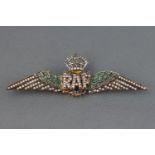A silver gilt RAF wings brooch set with emeralds and single cut diamonds. Stamped 925. 5.