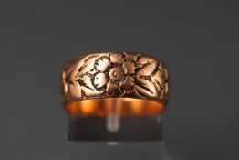 A rose metal wedding ring with cherry blossom engraved design.