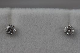 A pair of platinum and diamond studs approximately 0.30ct.