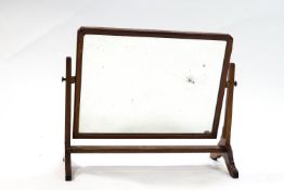 A mahogany framed rectangular swing framed mirror,