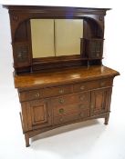 An oak Arts and Crafts sideboard with raised back and central mirror, circa 1900,