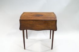 A George III mahogany butterfly Pembroke table with central medallion and satinwood and ebony