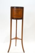 An Edwardian satinwood jardiniere with brass liner on three splayed legs, linked by an under-tier,
