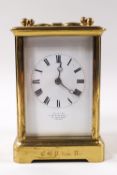 A brass framed four glass carriage clock, striking on a gong,
