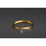 A yellow metal D shape wedding band with personal inscription. Tests indicate 22ct gold.