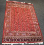 A Keshan style machine woven carpet with central medallion and all over floral decoration to the