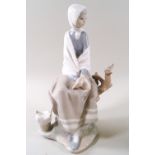 A Lladro porcelain figure of a seated girl with a bird upon a branch, 25cm high,