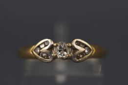 A yellow and white metal diamond ring with central oval brilliant diamond, approx 0.