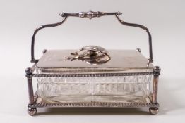 A silver plated and cut glass sardine dish with swing handle,