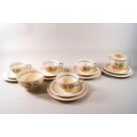 A 1940's Susie Cooper part tea set with flower decorations comprising of four cups and five saucers,