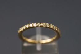 A yellow metal half hoop diamond ring. Stated total weight of 0.47ct.