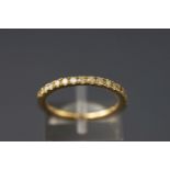 A yellow metal half hoop diamond ring. Stated total weight of 0.47ct.