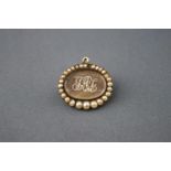 A 19th century gold and half pearl mourning brooch with plaited hair and pearl set initials.