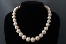 A single strand of cultured white pearls. Thirty two off round pearls.
