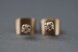 A pair of white metal single stone diamond stud earrings. Approx 0.15ct total diamond weight.