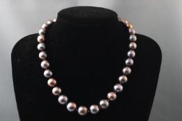 A single strand of cultured peacock pearls. Thirty three off round pearls.