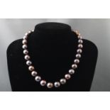 A single strand of cultured peacock pearls. Thirty three off round pearls.