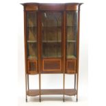 An Edwardian inlaid mahogany bow fronted display cabinet,