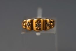 An Edwardian yellow metal three stone ring set with rose cut diamonds.
