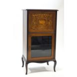 An Edwardian mahogany music cabinet,