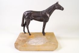 A soapstone ash tray, with bronze patinated figure or a horse, 20cm high, 20cm wide, 16.