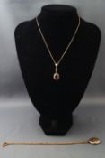 A yellow metal locket on fancy link chain,
