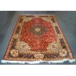 A Bokhara machine woven carpet with repeating design within multiple borders on a red ground,