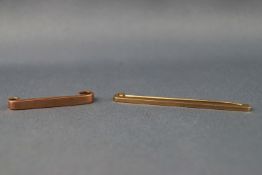 A selection of two stamped 9ct yellow gold tie pins of plain polished finish.