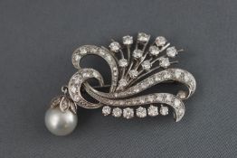 A white metal diamond spray brooch.