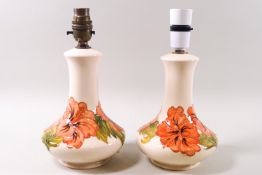 A pair of Moorcroft table lamps, hibiscus pattern on a cream ground, impressed factory marks,