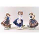 Three Lladro porcelain figures of girls carrying flowers.
