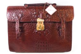 An early Mulberry attache case, in brown mock crocodile, with strap handle, a lock and two buckles,