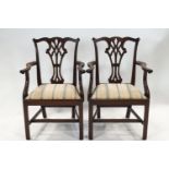 A pair of George III style mahogany elbow chairs with pierced splats,