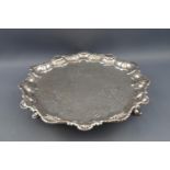 A George II silver salver, with shell and scroll cast rim, chased with flowers and C scrolls,