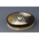 A Scottish horn snuff box with embossed silver thistle to lid.