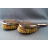 A pair of silver backed hair brushes,