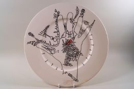 A Poole pottery plate decorated with a design by Uri Geller, applied factory mark.